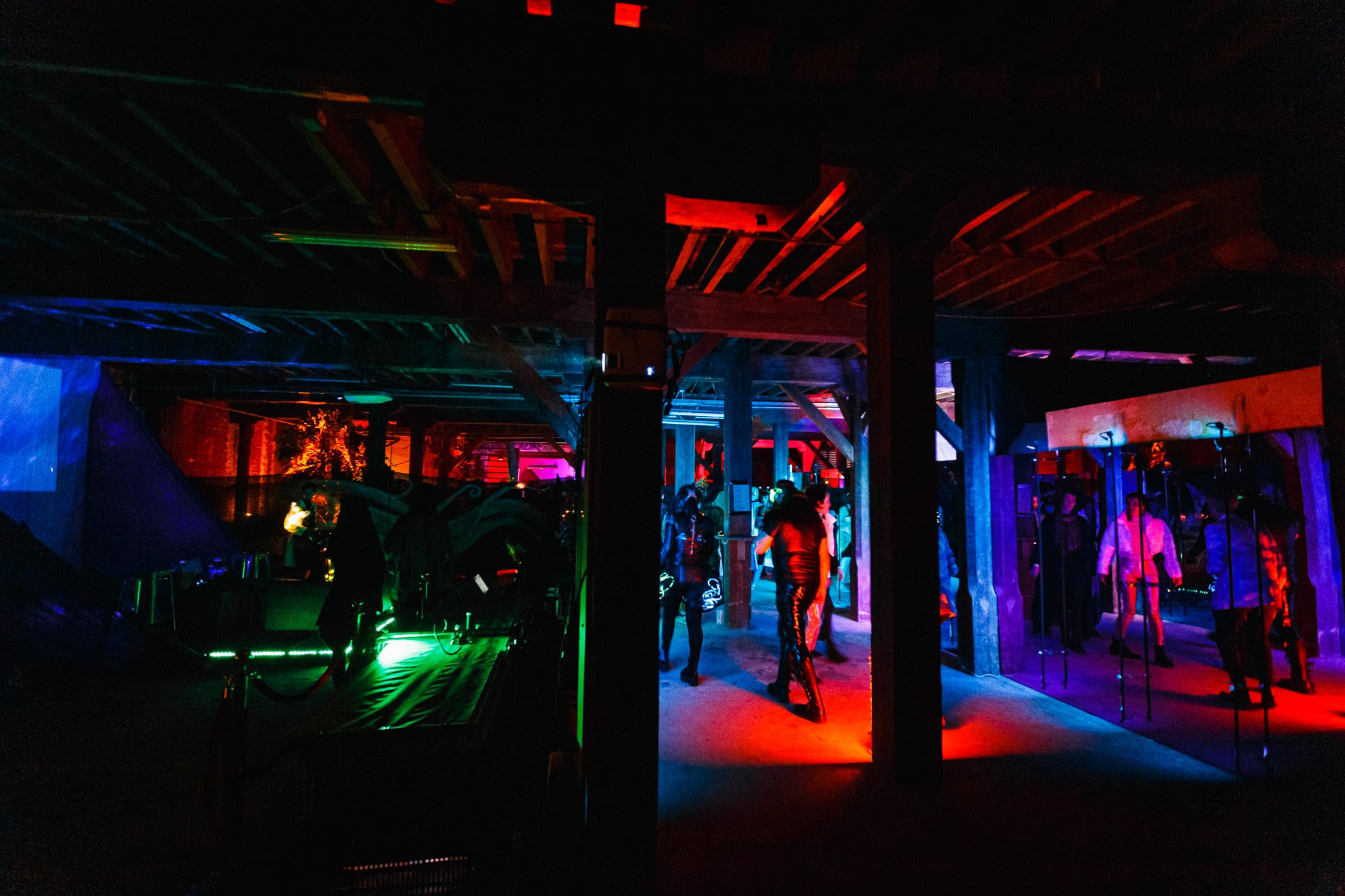 Warehouse lit in red, green and blue for an immersive event.