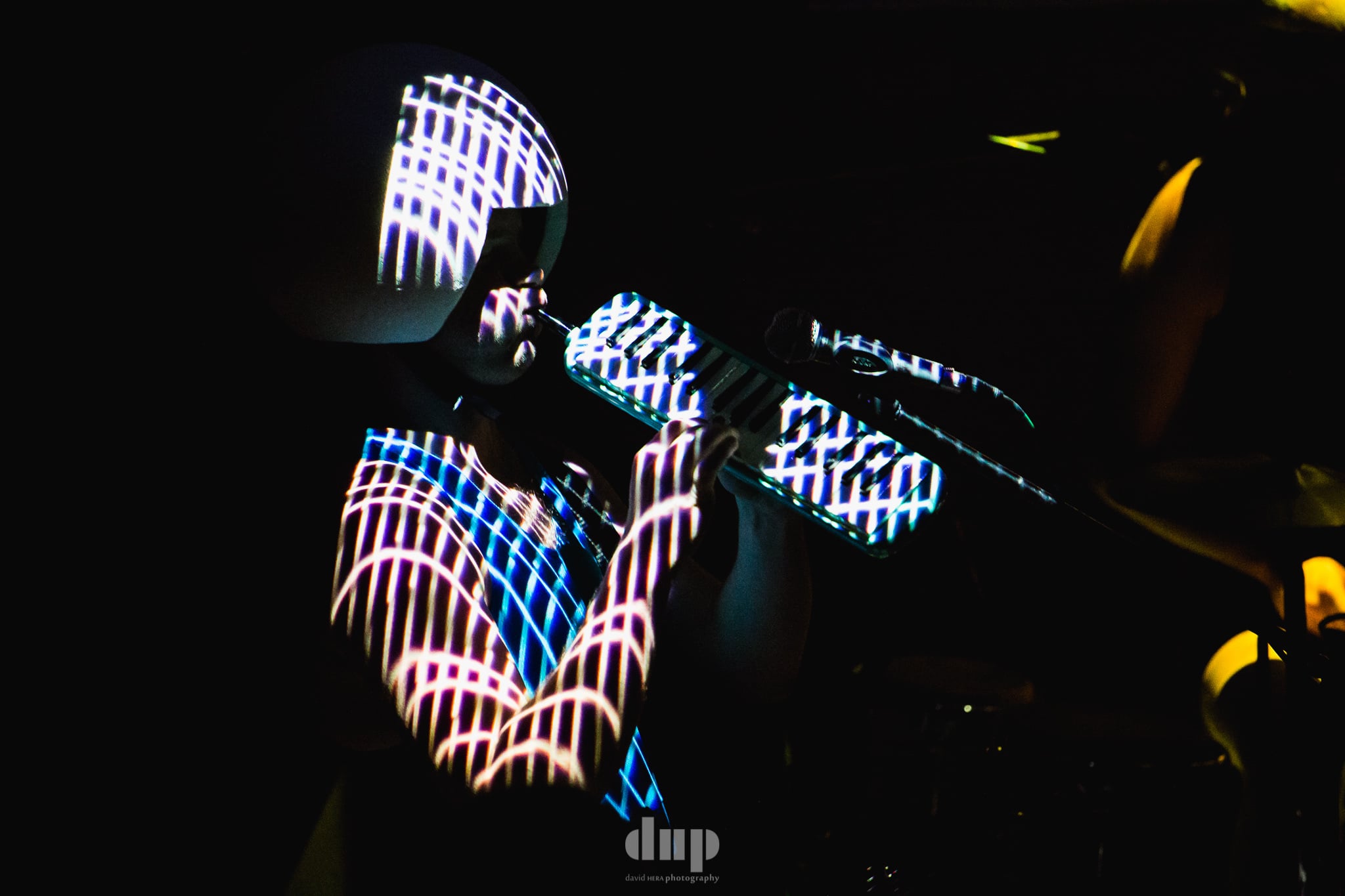 Light-painted patterns streaking across a darkened stage.
