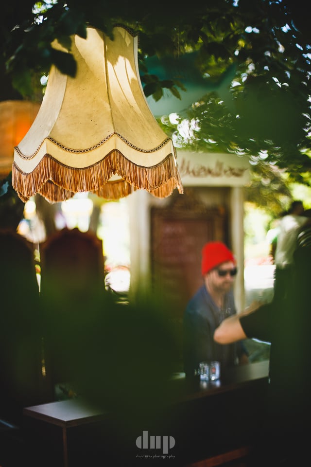 Vintage lampshade strung above a festival bar.