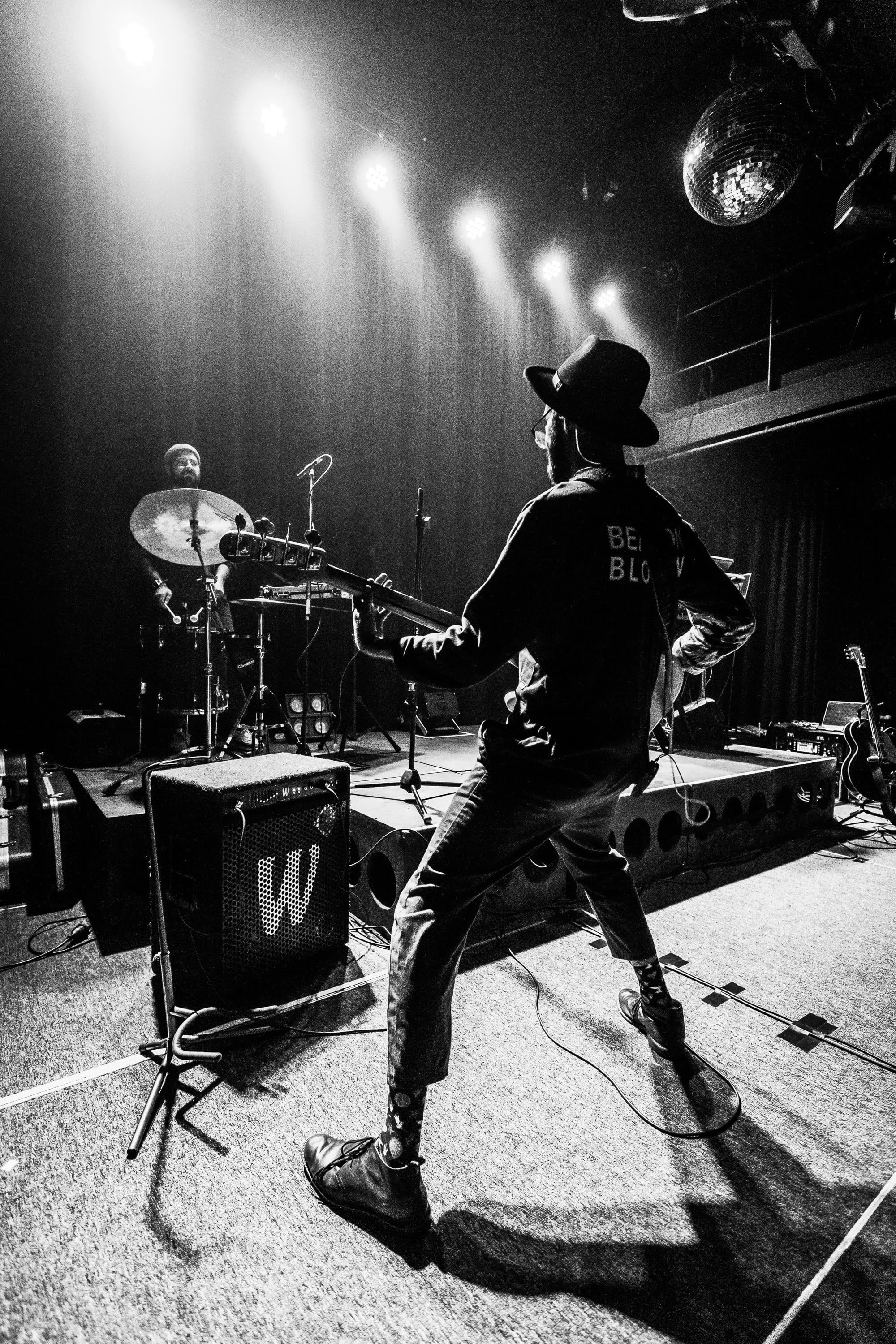 Guitarist on stage, black and white.