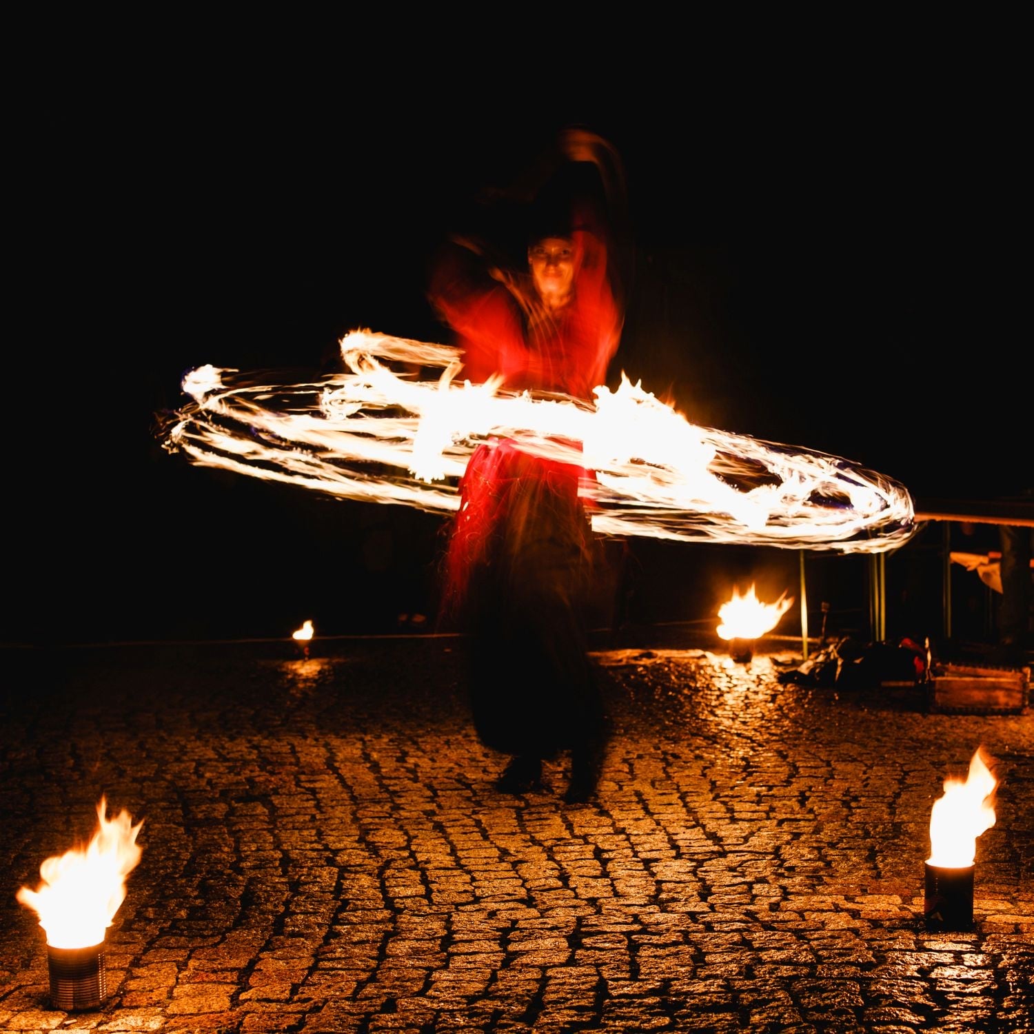 Fire performer spinning at a wedding reception.