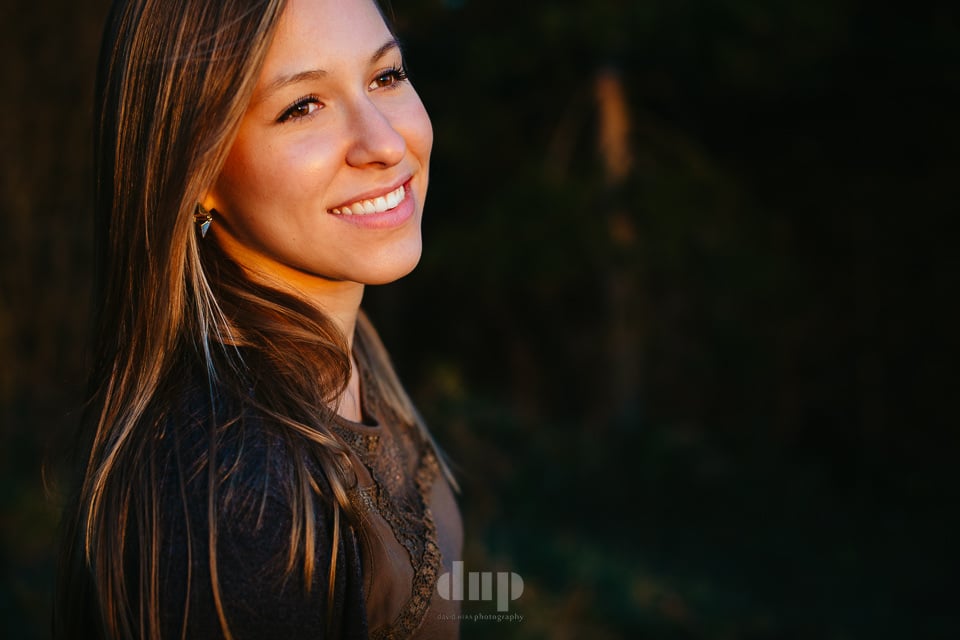 Woman smiling in warm evening light.