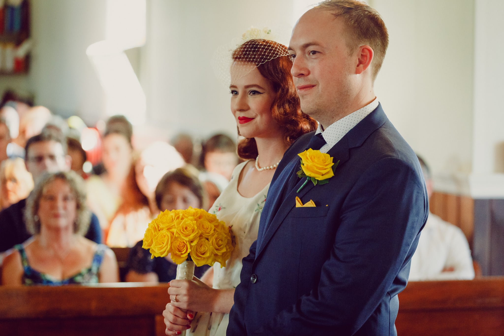 Couple at the altar with guests looking on.