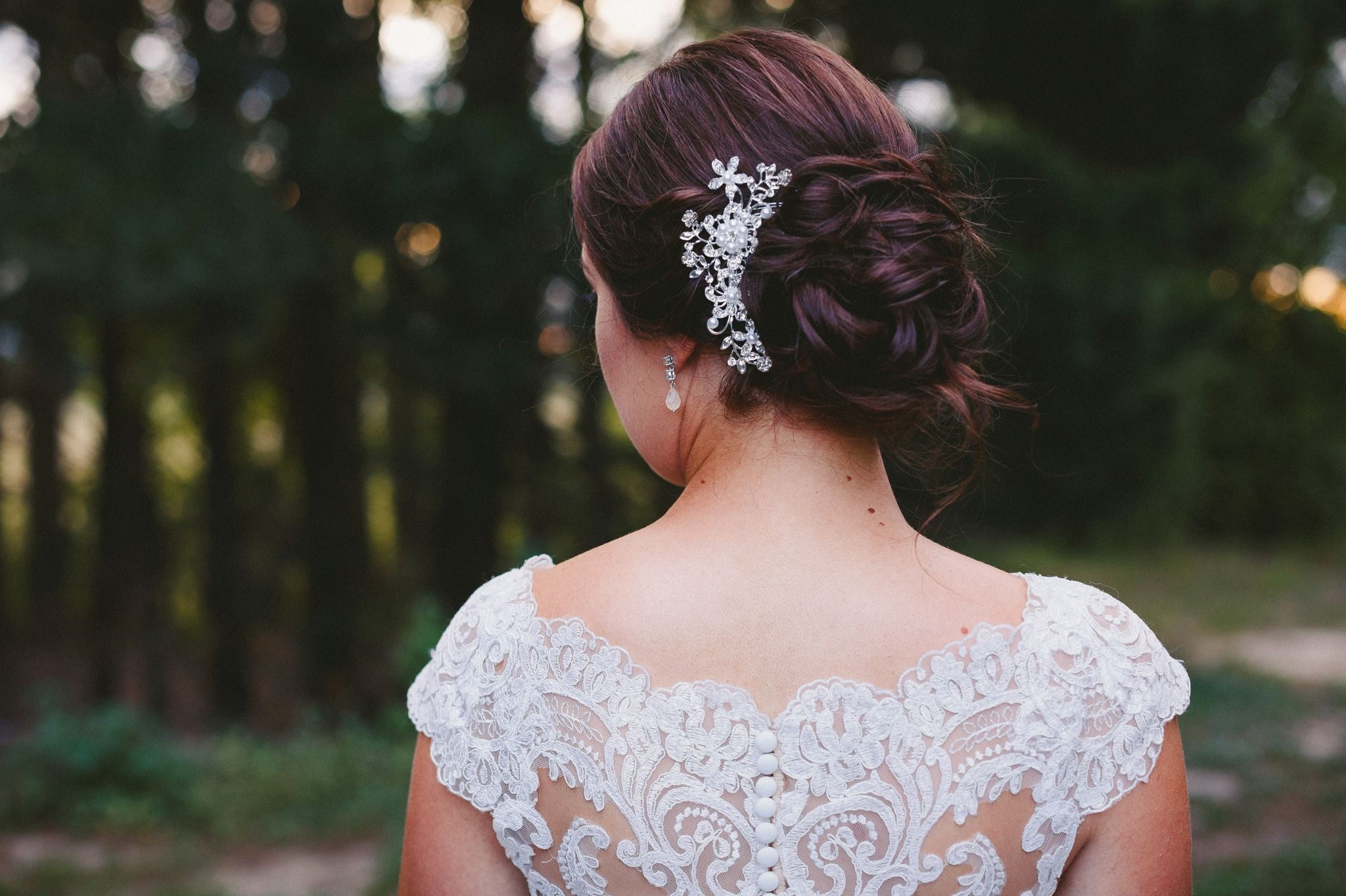 Lace and hairpiece detail on the back of a wedding dress.