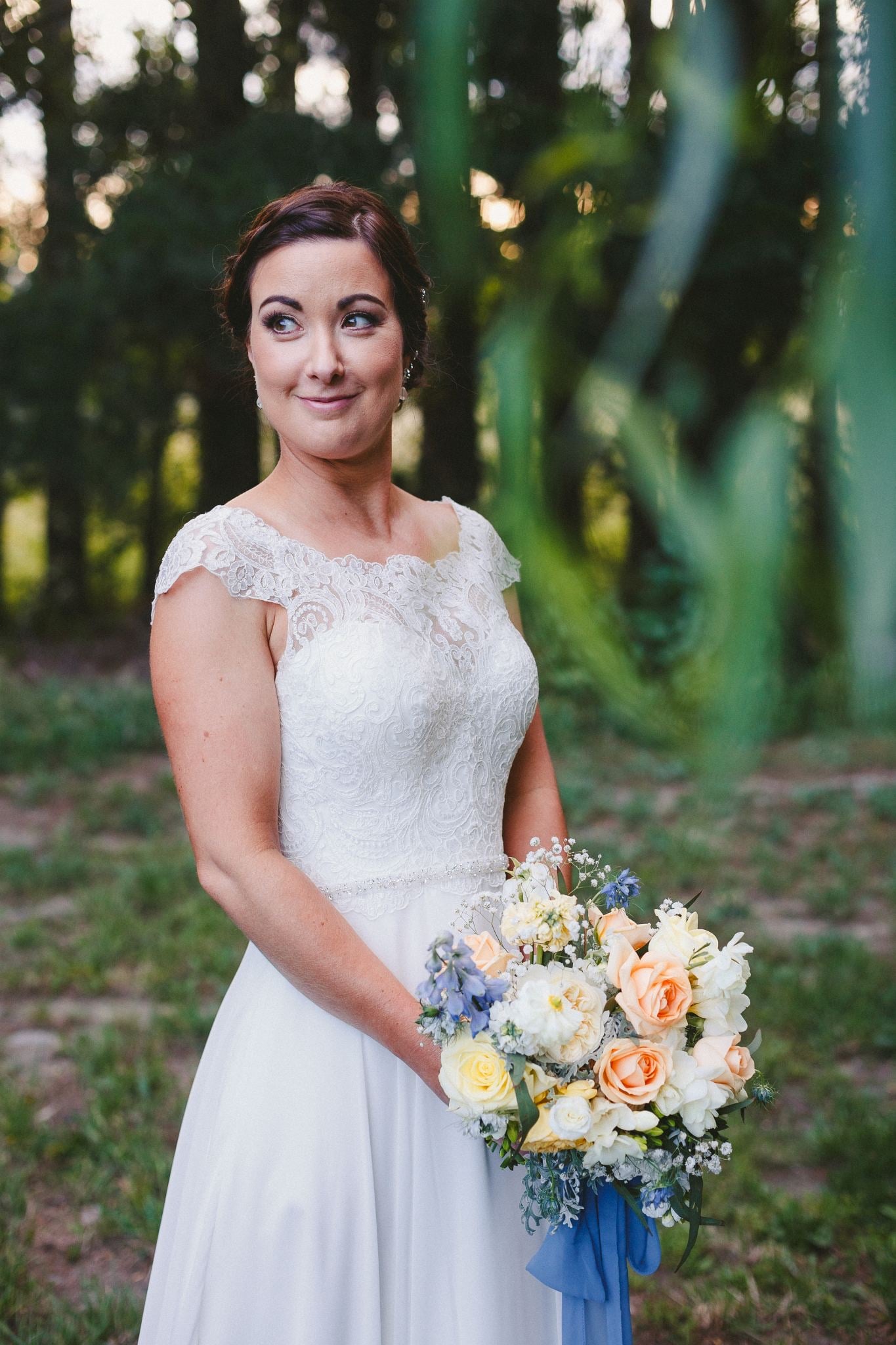 Bride holding a pastel bouquet.