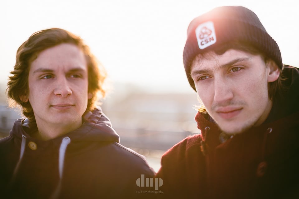 Two musicians backlit by low winter sun.