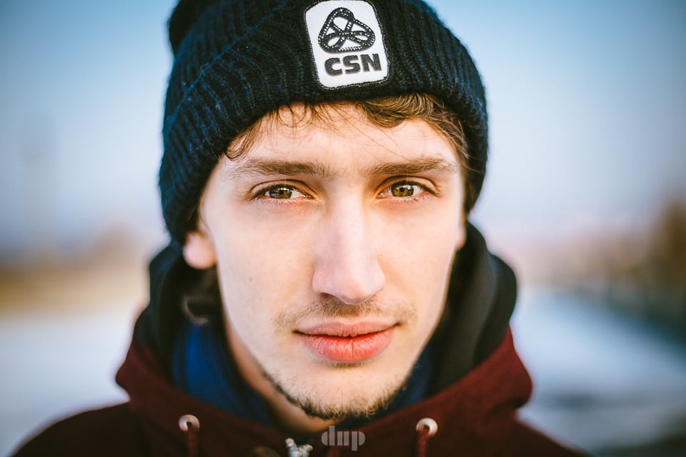 Young man in a beanie by the river.