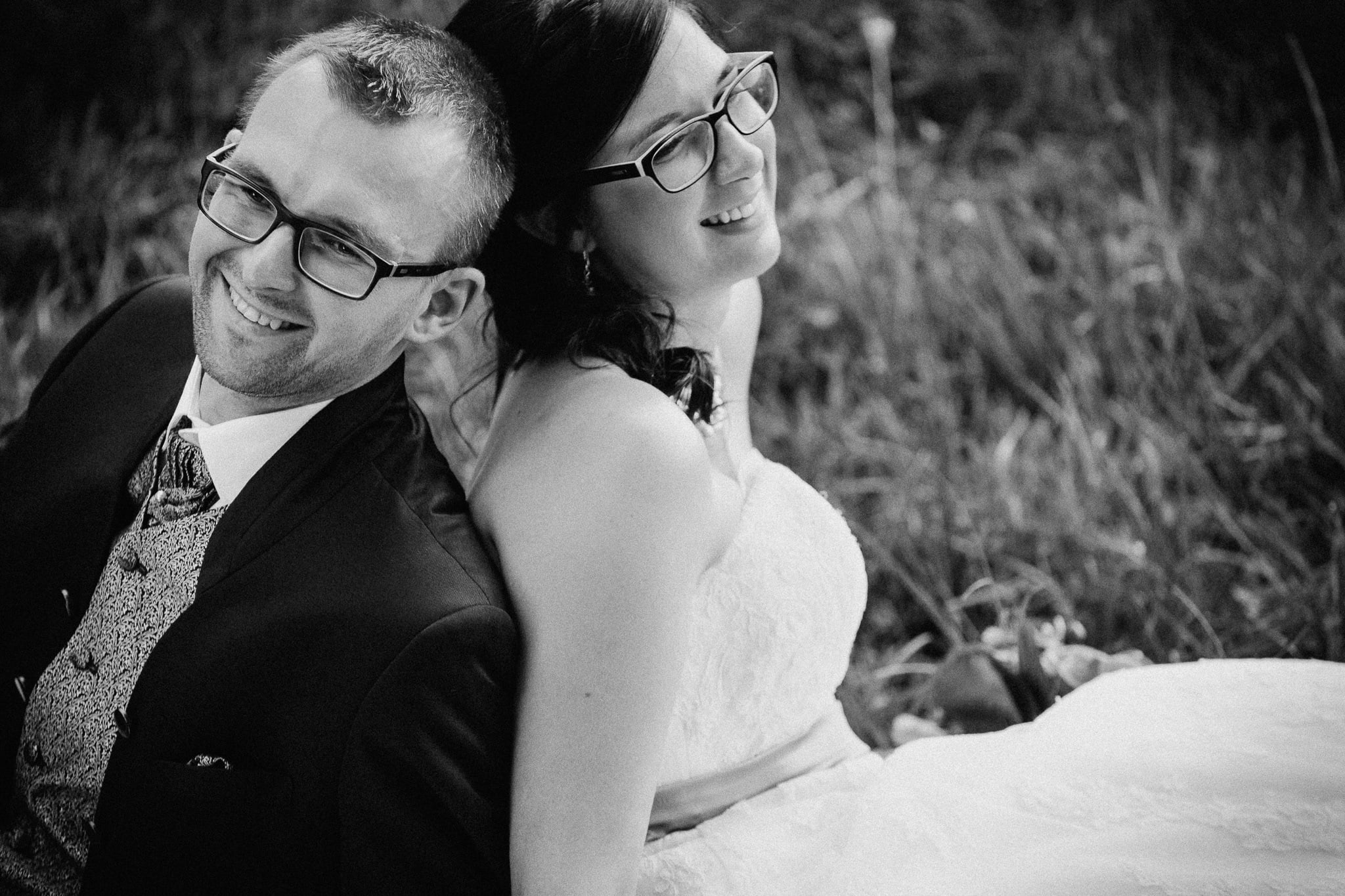 Black-and-white portrait of a laughing couple.